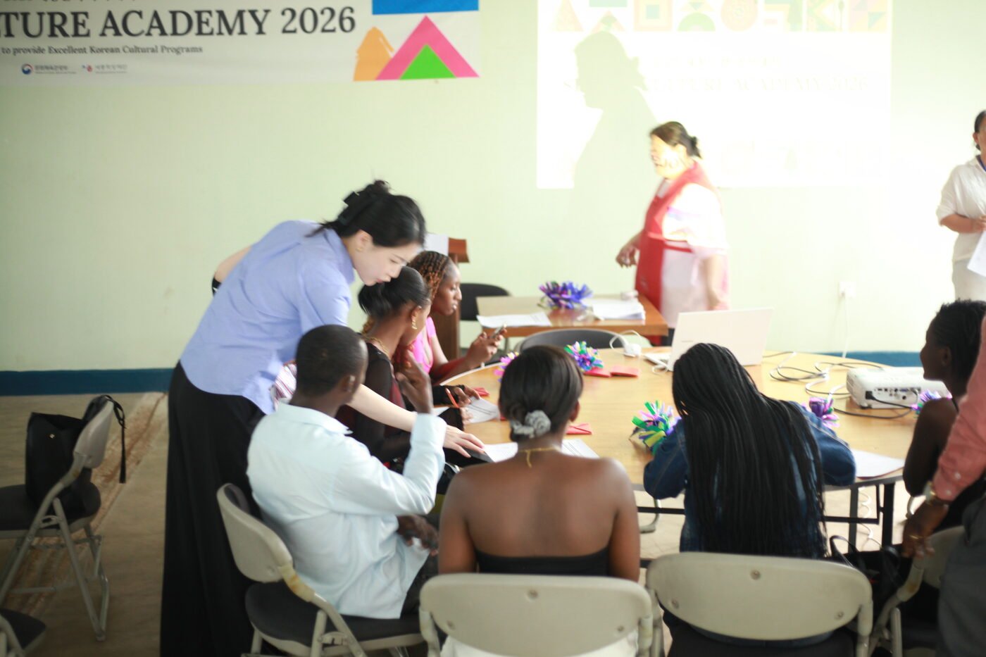 Instructor Yu Yeong Ran guiding participants through a Korean craft activity at tables