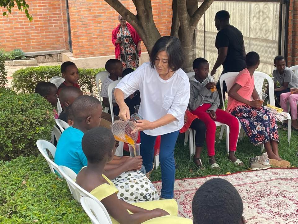 UAIT faculty serving drinks to children