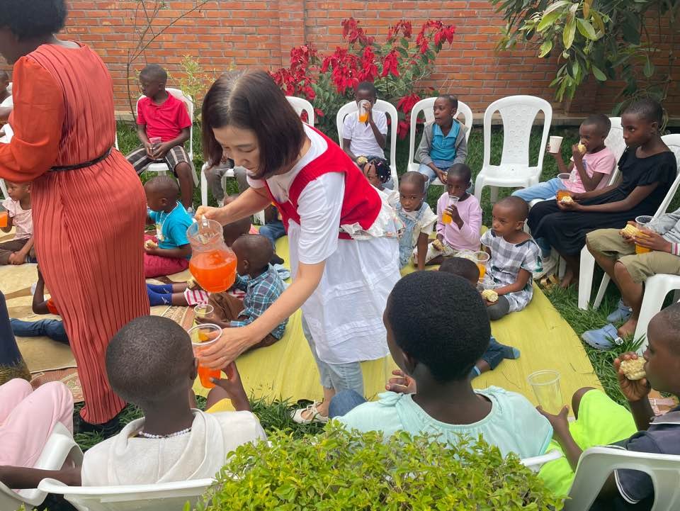 Faculty serving refreshments to children