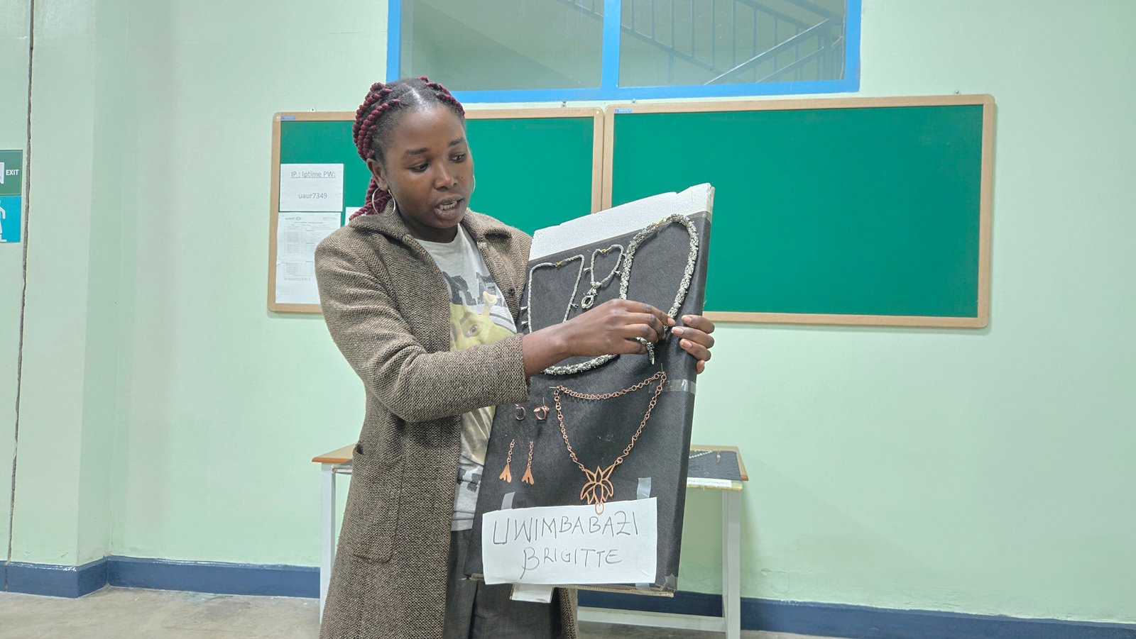 Uwimbabazi Brigitte showcasing necklace designs