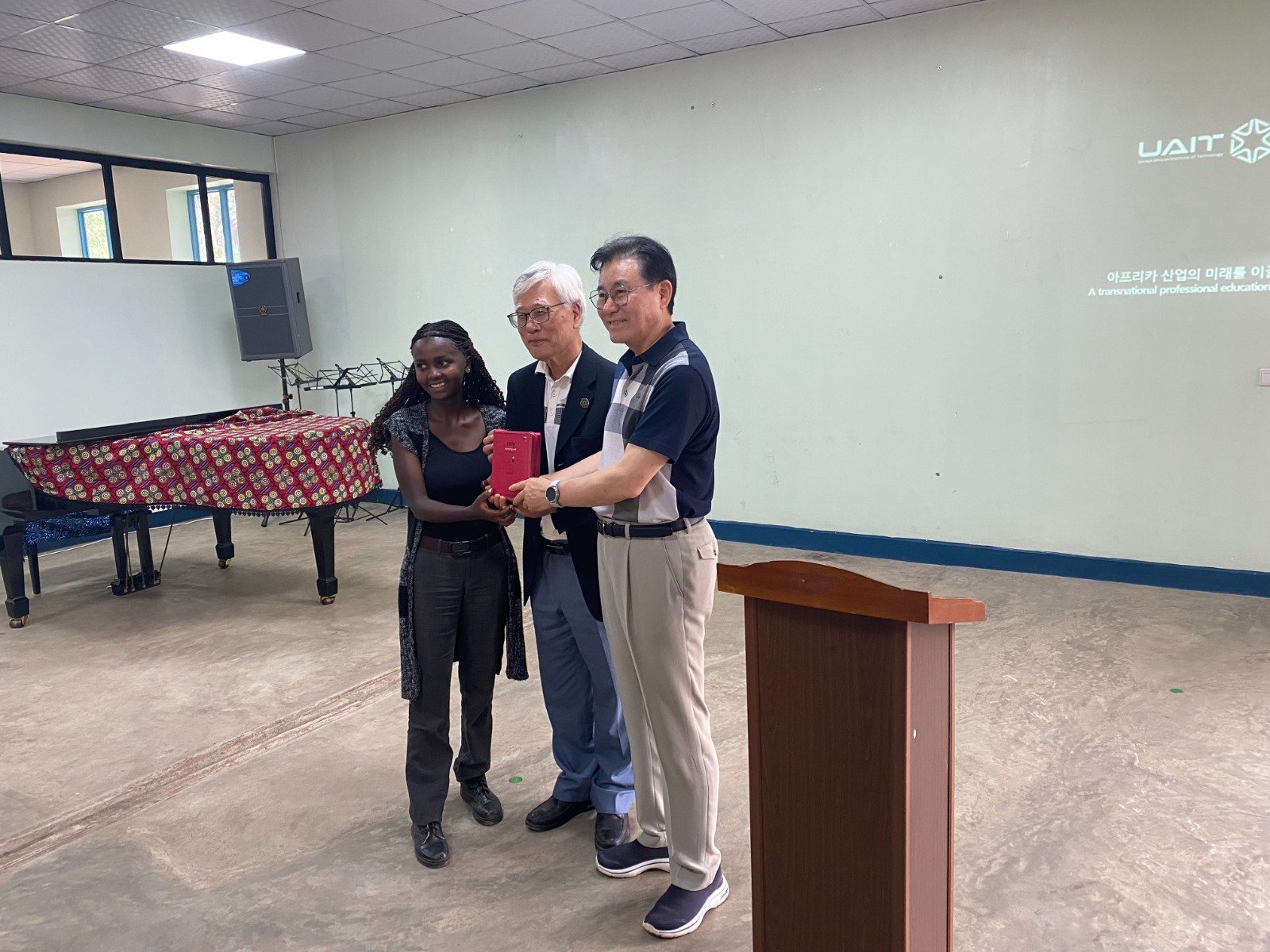 A UAIT student receiving a Bible during the fellowship