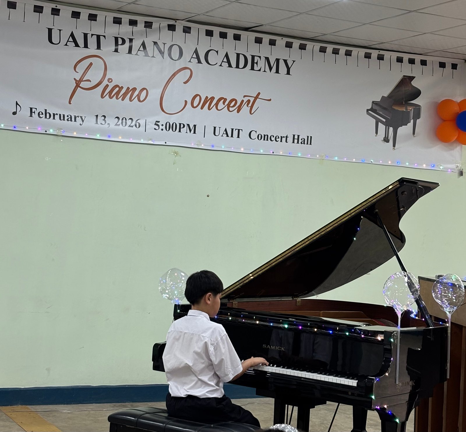 Young boy focused on his piano performance
