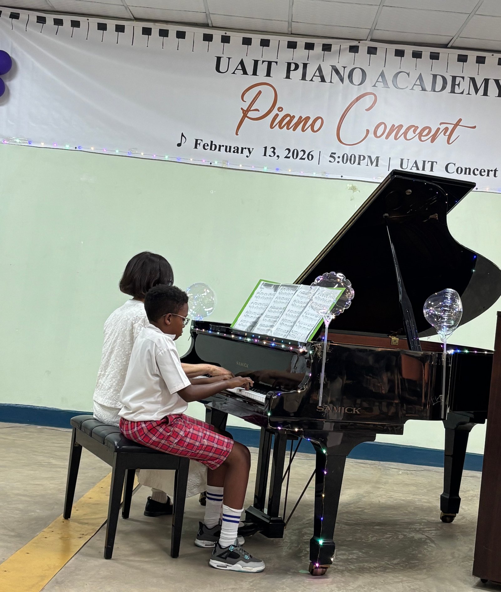 Student performing with teacher guidance at the piano